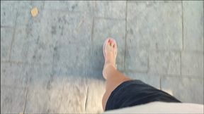 Mature woman driving driving and pumping pedals through the city (1)