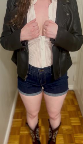 Woman in denim shorts and leather jacket