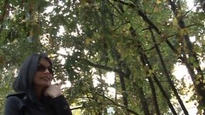 Hot and sexy milf fingers her pussy on the bench of a park