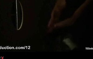 Tranny jerks off cock to guy through glory hole