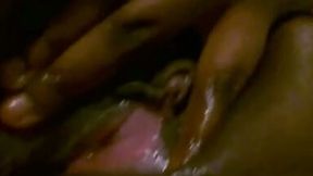 Salacious ebony chick fingers her oiled crotch in homemade video