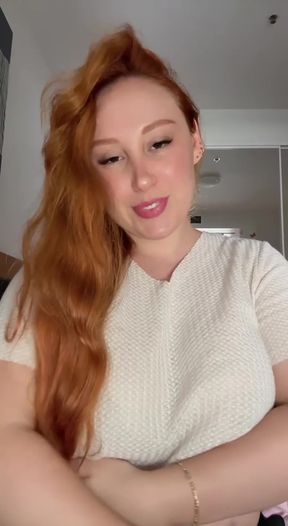 Red-haired woman in white top