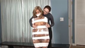 Bubbly Blonde Ashley Abbott Squirms In Her Plastic And Tape Body Wrap!