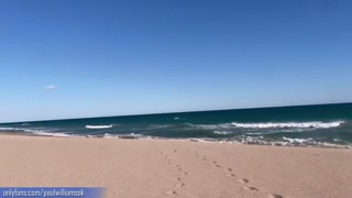 Fitness young man gets naked on Barcelona public beach after gym workout