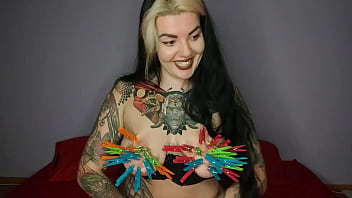 Tattooed, kinky girl hangs the maximum number of clothespins on her big tits