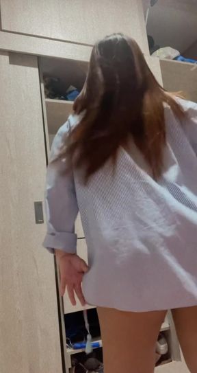 Woman in blue shirt walking through room