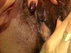Ebony babe shoves a huge dildo in blonde MILF's cunt