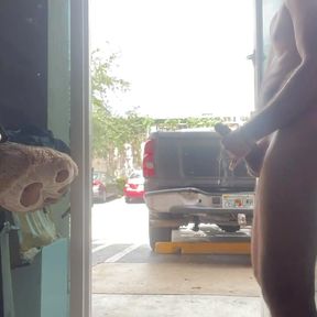 Jerking naked at the front cristal door