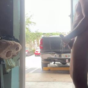 Jerking naked at the front cristal door