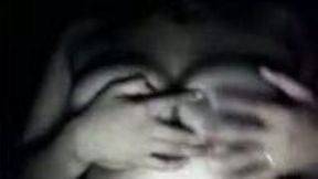 Girl presenting her big natural boobies in the dark