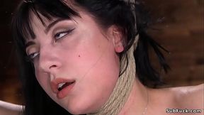 Brunette hogtied in a hip suspension
