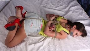 Tapegagged high-heeled Heidi in yellow tank top and cut-off jeans shorts, rope hogtied with her feet crossed, is trying to move somehow (HD MOV)