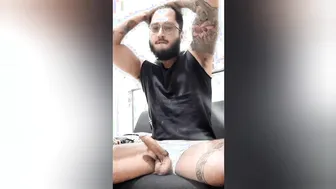 Tattooed guy strokes his hard dick and pisses in solo session