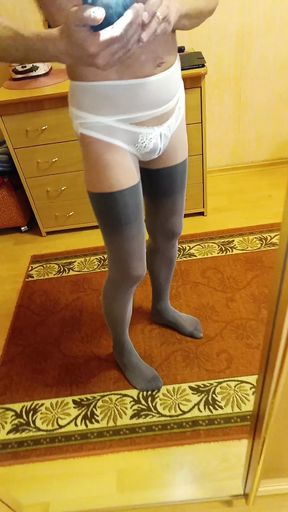 I&#039;m wearing tights and panties and looking at myself in the mirror.
