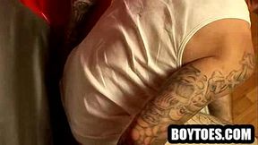 Tattooed hunk shows his feet off and tugs his cock