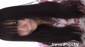 Japanese girl enjoys teasing her cat with pee-filled cups