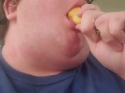 Fat male testing throat with banana