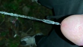 Slowmotion and Close up. Unwashed Uncut Cock Piss on the Ground Outdoor. Long Piss Stream