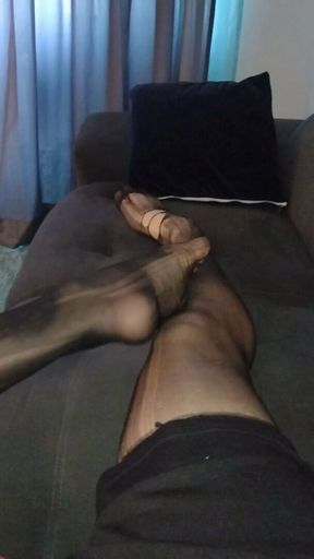 Latino playing with his feet ( Sheer socks)