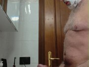 Horny daddy shaves his beard and pubes, then cums with his big cock.