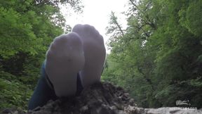 Teasing feet in white socks at the waterfall