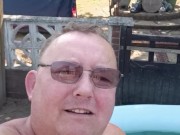 Sun bathing in paddling pool, naked