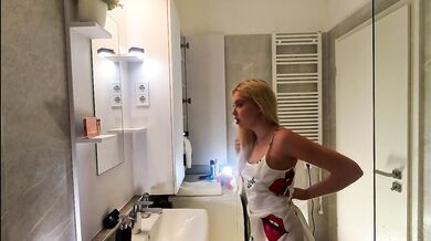 Sexy beauty cute blonde horny girl in pink panties and with a satin nightie does the bathroom routine before going to the bed