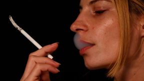 Eve, the glamorous blonde, enjoys her cigarette in mesmerizing slow motion.