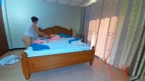 Nudist housekeeper Regina Noir makes the bedding in the bedroom. Naked maid. Naked housewife. c2