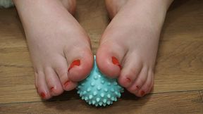Playing with toes with a massage ball