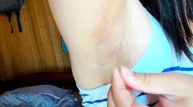 She brushes off the loose underarm hair with a sigh
