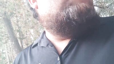 Amateur bearded dude is filming himself while walking through nature