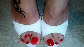 Cougar Showing Off Her Glamorous Red Toe Nails And Toe Rings In Heels