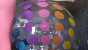 girl play on giant beachball and ride on egg ball
