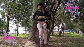 young woman using a vibrator and anal plug in a public square in curitiba