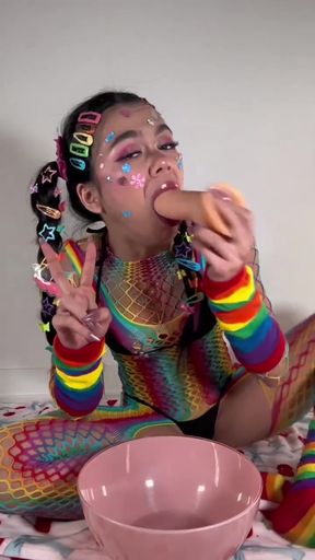 Colorful clown eating a hot dog