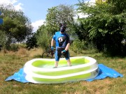 Cyclist pup in pool - cooling down and pawing off