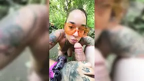 Tattooed chick sucks member during outdoor break