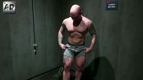 Gym jock strips off shows muscles and plays with his big uncut cock in public toilet cruising