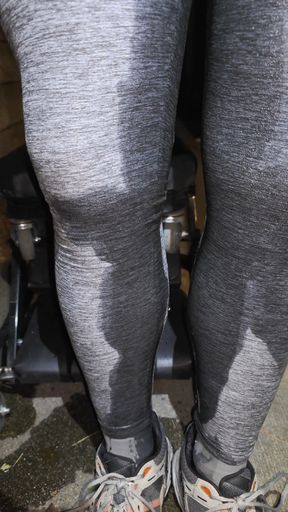 Wetting gray leggings and sneakers outside on rolling stool