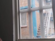 masturbating in the window facing the street