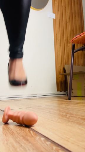 Heel sinks into tiny dildo, teasing fragile psyche