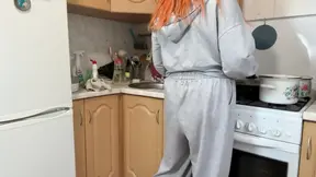 A beautiful and busty Russian teen with a hot pussy is in the kitchen.