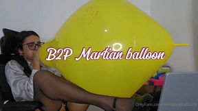 This secretary makes a great blow to pop with her Martian balloon