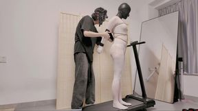 A girl in white stockings trains on a treadmill until she's exhausted