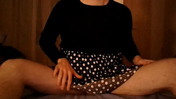 Crossdresser in polkadot dress having fun alone at home