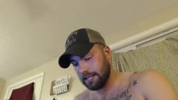 Hairy Guy with Tatoos on Couch