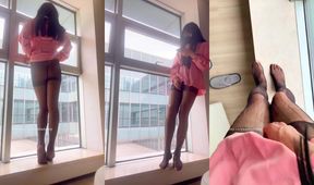 Yuanladyboy squirting black stockings in front of floor-to-ceiling windows