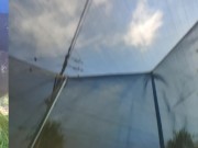 Tall girl in shorts jumping barefooted on a trampoline (slowed down) bottom view