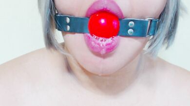 Ball gag moaning drips down her chin while she fights to keep it silent